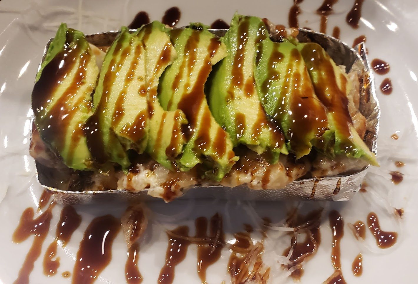 Baked Dynamite Go Fish Sushi Bar - Thousand Oaks, CA A delicious mixture of shrimp, scallops, mushrooms, rice and sweet onion, baked in our secret mayo sauce, then topped with avocado and sweet sauce