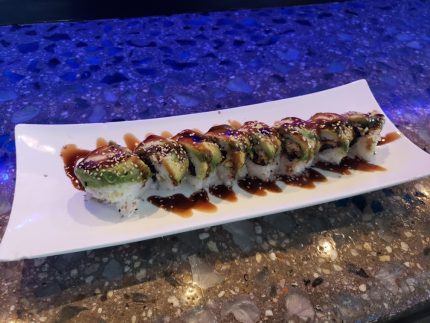 Inside: shrimp, crab meat and cucumber
Outside: avocado drizzled with sweet sauce