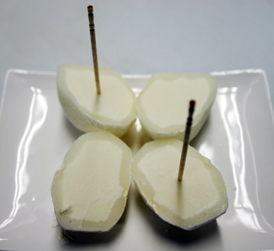 Small round dessert ball of ice cream wrapped in a rice cake covering strawberry, vanilla, kona coffee, green tea, mango