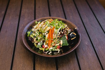 Mixed greens, gobo root and avocado on top of a tuna and crab roll, drenched in our secret sweet and sour dressing - delicious!