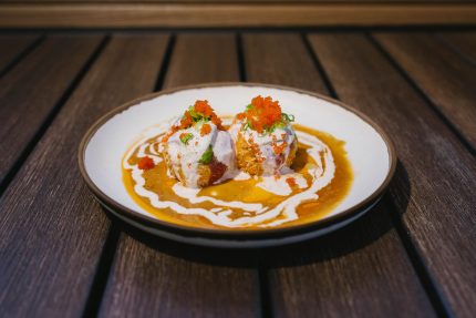 Tuna, albacore, and avocado, wrapped around a spicy crab ball, with a mixture of sauces and masago