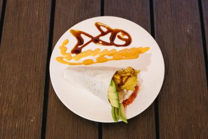 Shrimp tempura, spicy tuna, crab meat, avocado, with spicy sauce and sweet sauce topped with tobico, wrapped in soy paper.