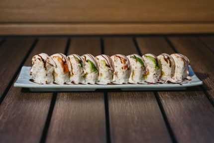 Inside: shrimp tempura, crab meat and cucumber
Outside: shrimp and avocado drizzled with sweet sauce