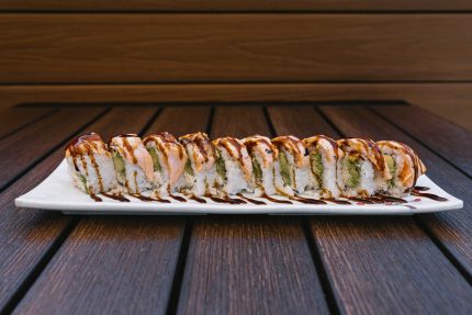 Inside: crab, cucumber and avocado
Outside: baked salmon drizzled with sweet sauce