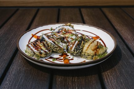 Inside: freshwater eel, spicy tuna, avocado Outside: deep-fried tempura batter, drizzled sweet sauce and green onion