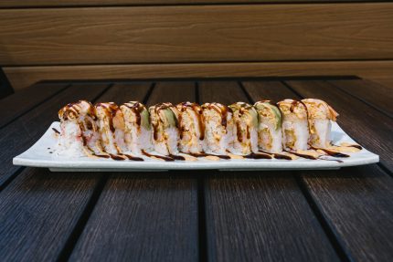 Inside: shrimp tempura and crab
Outside: spicy crab, avocado, drizzled with spicy mayo and sweet sauce all wrapped in a pink soy paper!