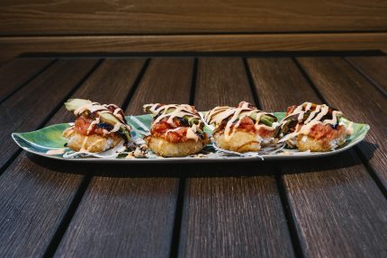 Tempura fried rice ball topped with spicy tuna and avocado drizzled, then drizzled with sweet and spicy sauce